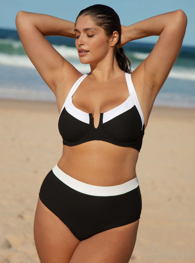 A model wears a black and white bikini made by Berlook